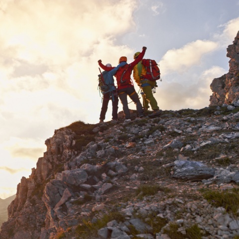 Mountain climbers celebrating at the top of a mountain